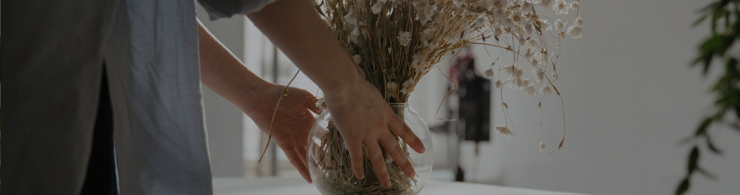 a flower vase held by someone