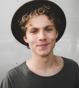 John Mathews in hipster hat and green t-shirt