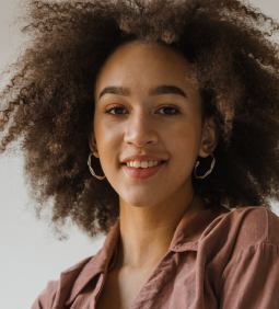 Rae Romano with big earrings and stylish blouse