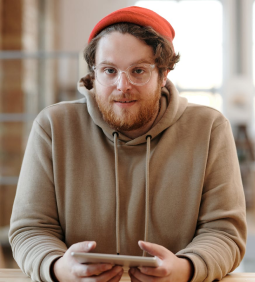 Marjorie Williams in red beanie and beige hoodie